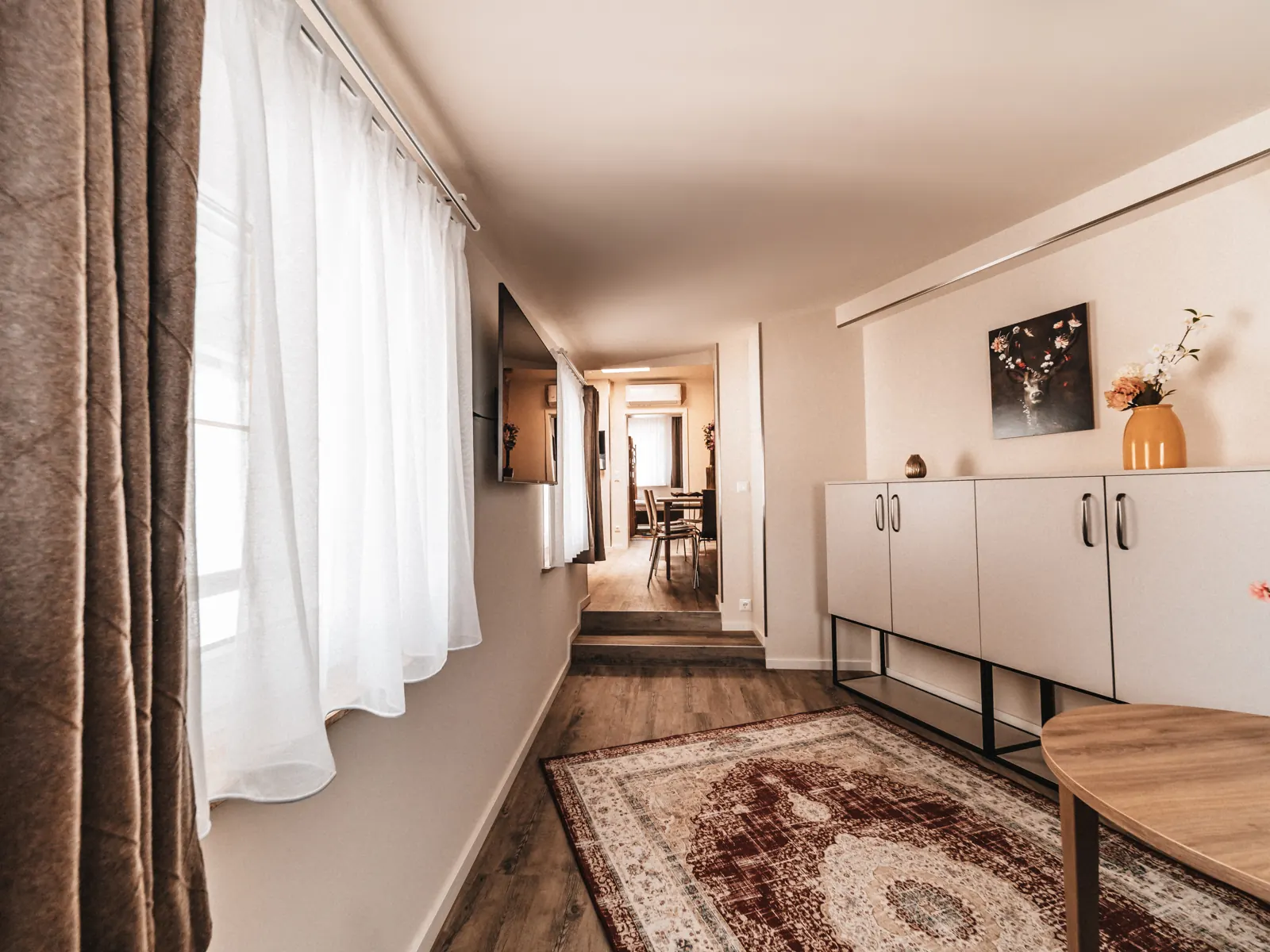 Living area of the Big Family Apartment with sofa and kitchen