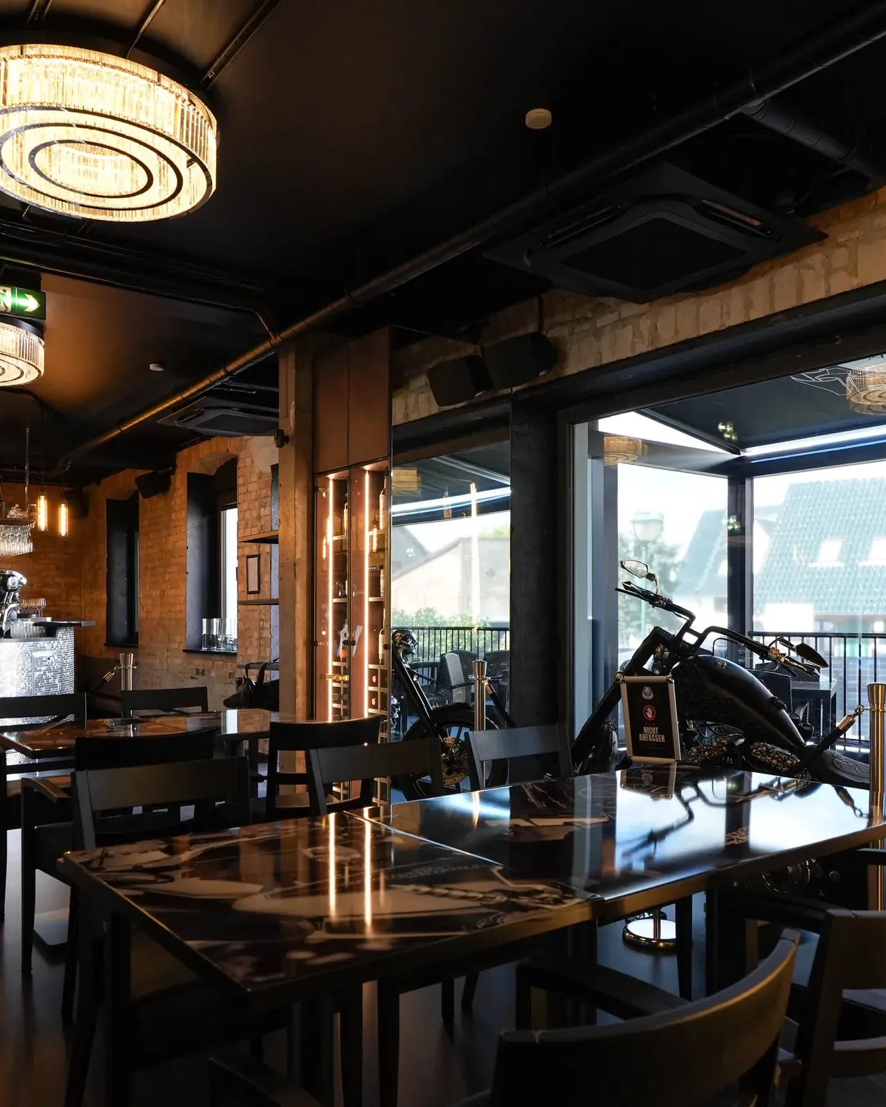 Restaurant of the Silberwolf Biker Bar with brick walls and tables by the windows